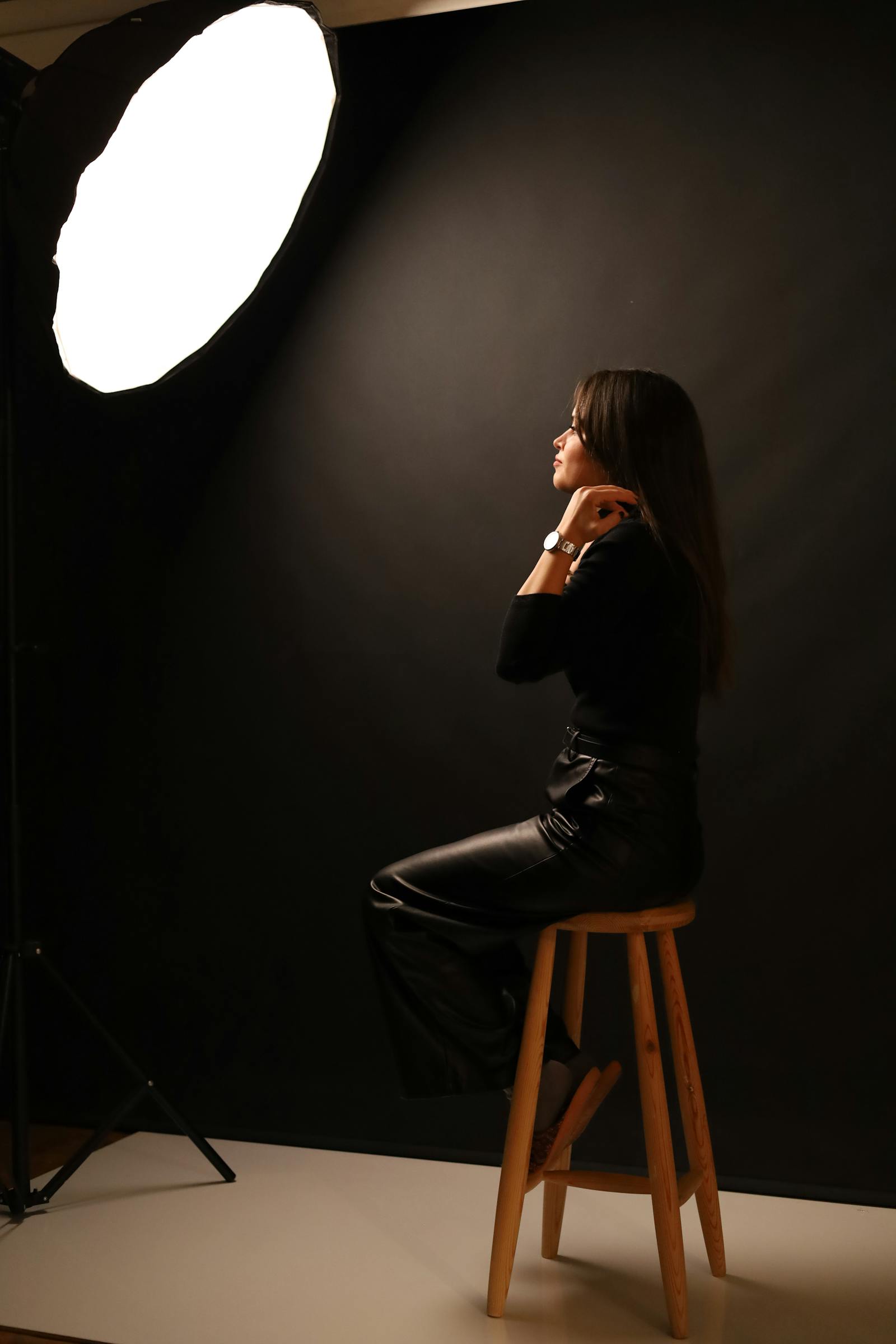 A printed proof sheet next to a calibrated monitor, the proof showing a sequence of skin-tone patches under different studio lighting.